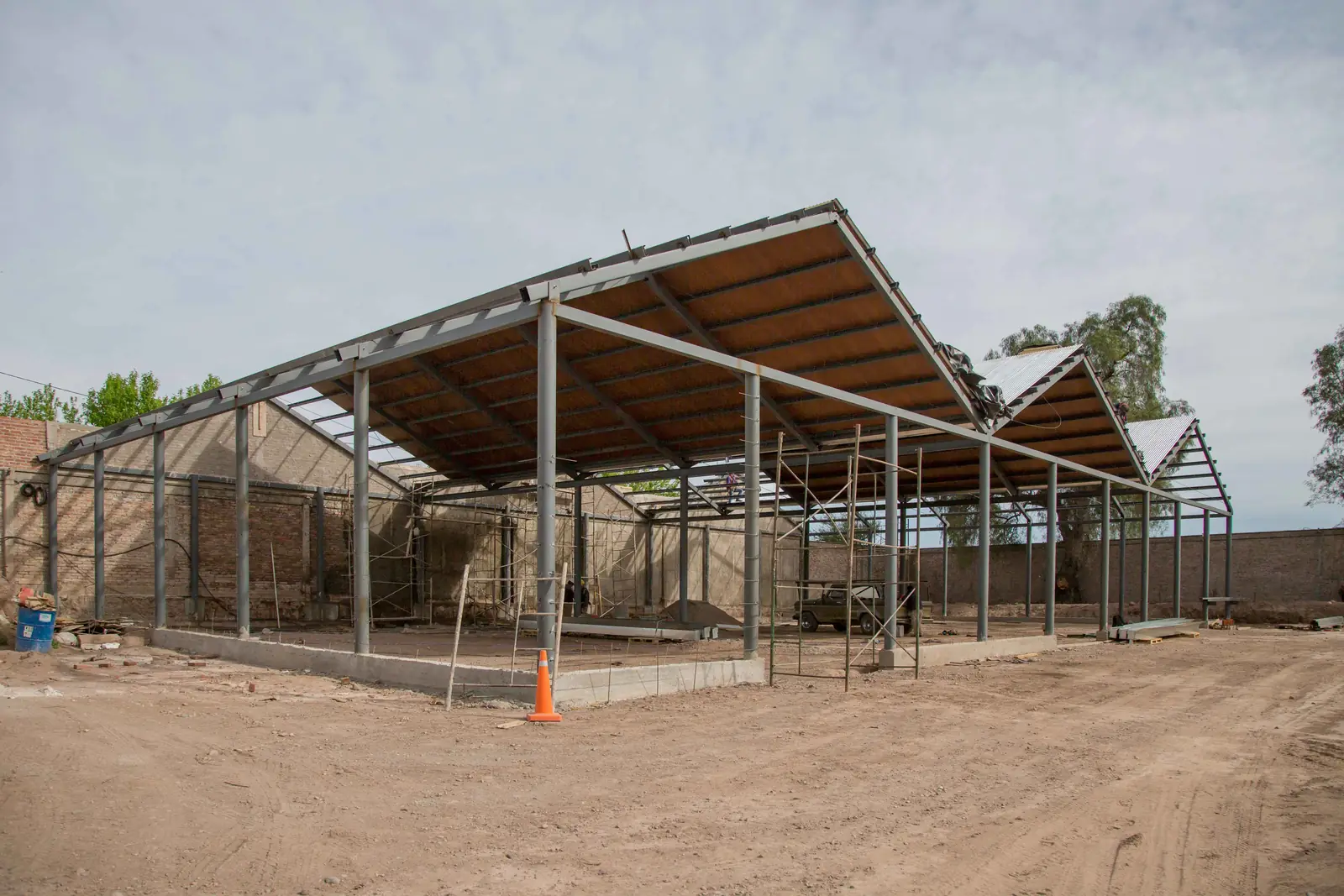 Estructura metálica con cubierta parcialmente colocada sobre el patio de la bodega